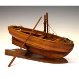 Mid 20th Century model boat of single masted form with oak, coiled rope and life ring, 38cm long, on