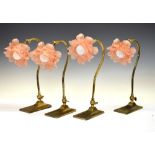 Four gilt metal desk or bedside lamps, frosted glass shades formed as flowerheads, 35cm high
