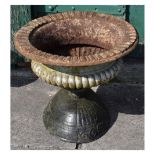 Cast metal garden planter in the form of a classical urn standing on another cast metal planter