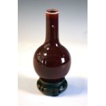 Chinese sang de boeuf vase with four character underglaze mark to base, on carved hardwood stand,
