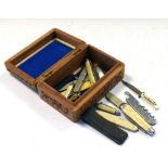 Quantity of bone and other handled pocket knives, within small table top carved wooden box