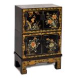 Oriental black lacquer cabinet, with decorated roof over two registers each of twin cupboard doors