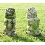 Pair of stone effect garden ornaments in the form of lions holding a shield, 41cm high Condition:
