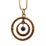 Yellow metal, sapphire and diamond pendant of concentric design with wreath and ring motifs, stamped