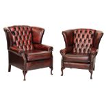 Pair of deep-buttoned red leather wing arm chairs for a lady and gentleman, each with studded arm