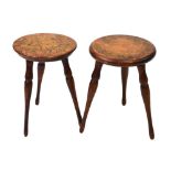 Pair of tripod stools, the seats with floral decoration, 32cm high Condition: Overall wear to