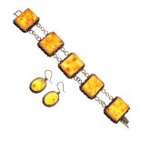 Silver bracelet having five rope-edged amber-coloured panels between belcher links, each panel