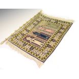 Small Eastern silk rug, having four central panels on a cream ground with green borders, 44cm x 59cm