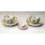Pair of Meissen cups and saucers with encrusted and painted floral decoration, together with a