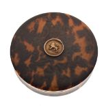 Circular tortoiseshell box, having central lion motif, 10cm diameter approx Condition: Scratches