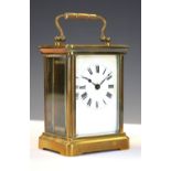 20th Century French brass cased carriage clock with white Roman dial, 11cm high excluding handle,