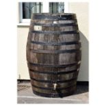 Large metal bound barrel with tap and metal plate marked Hutton, 93cm diameter x 129cm high