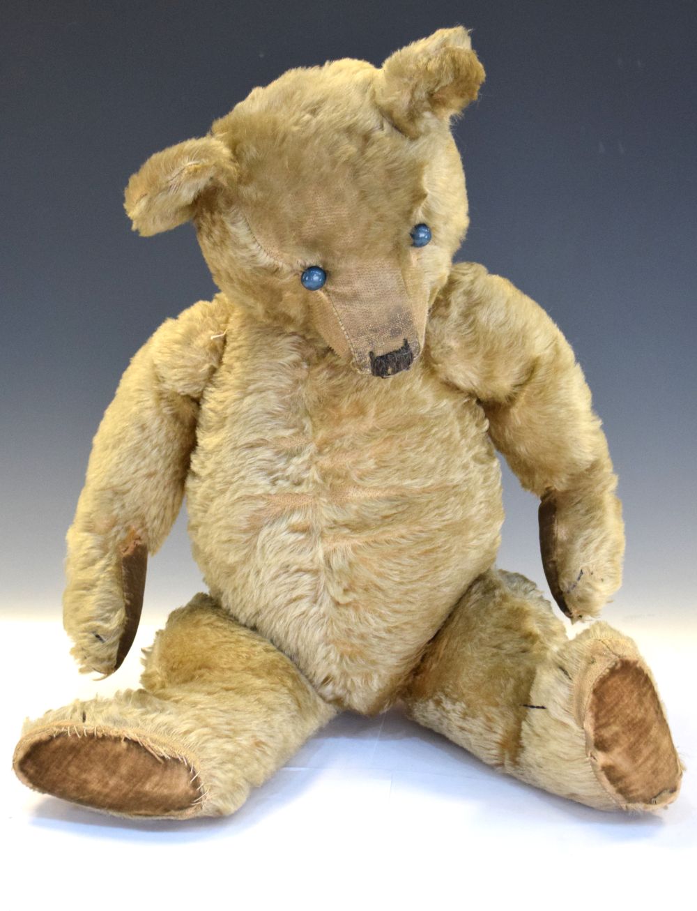 Early 20th Century golden mohair teddy bear, 60cm high Condition: Loss of mohair in places, would