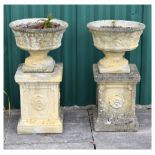 Pair of modern composition stone effect garden planters with vine leaf decoration, standing on a