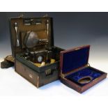 George V gentleman's travelling dressing set in green hide case and canvas cover, the interior