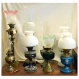 Eight oil lamps, all of various designs and heights, the tallest 79cm high Condition: Some small