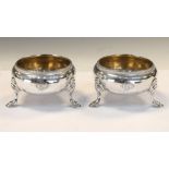 Pair of George V silver salts, each standing on three hooved feet, London 1911, 4.3cm high, 170g