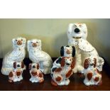 Group of eight Staffordshire pottery spaniels, the largest 36cm high Condition: Crazing to the glaze