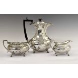 George V silver four-piece tea set of shaped form and standing on four hoof feet