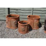 Three quatrefoil terracotta planters
