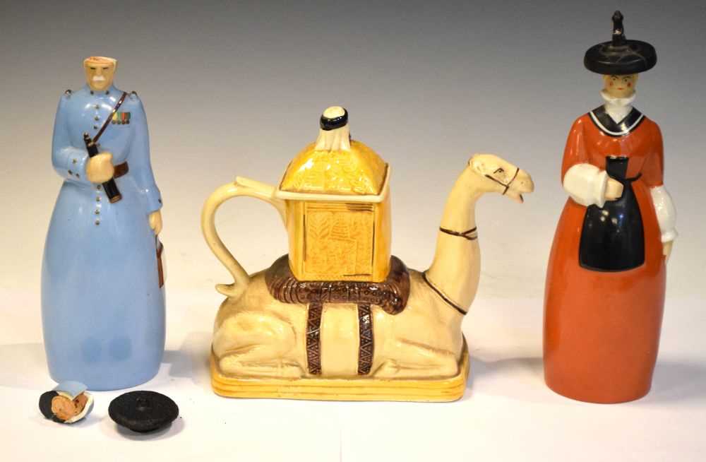 Two Roby, Paris figural decanters and a camel teapot