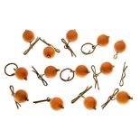Collection of thirteen amber bead buttons,