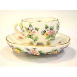 Meissen floral encrusted cup and saucer