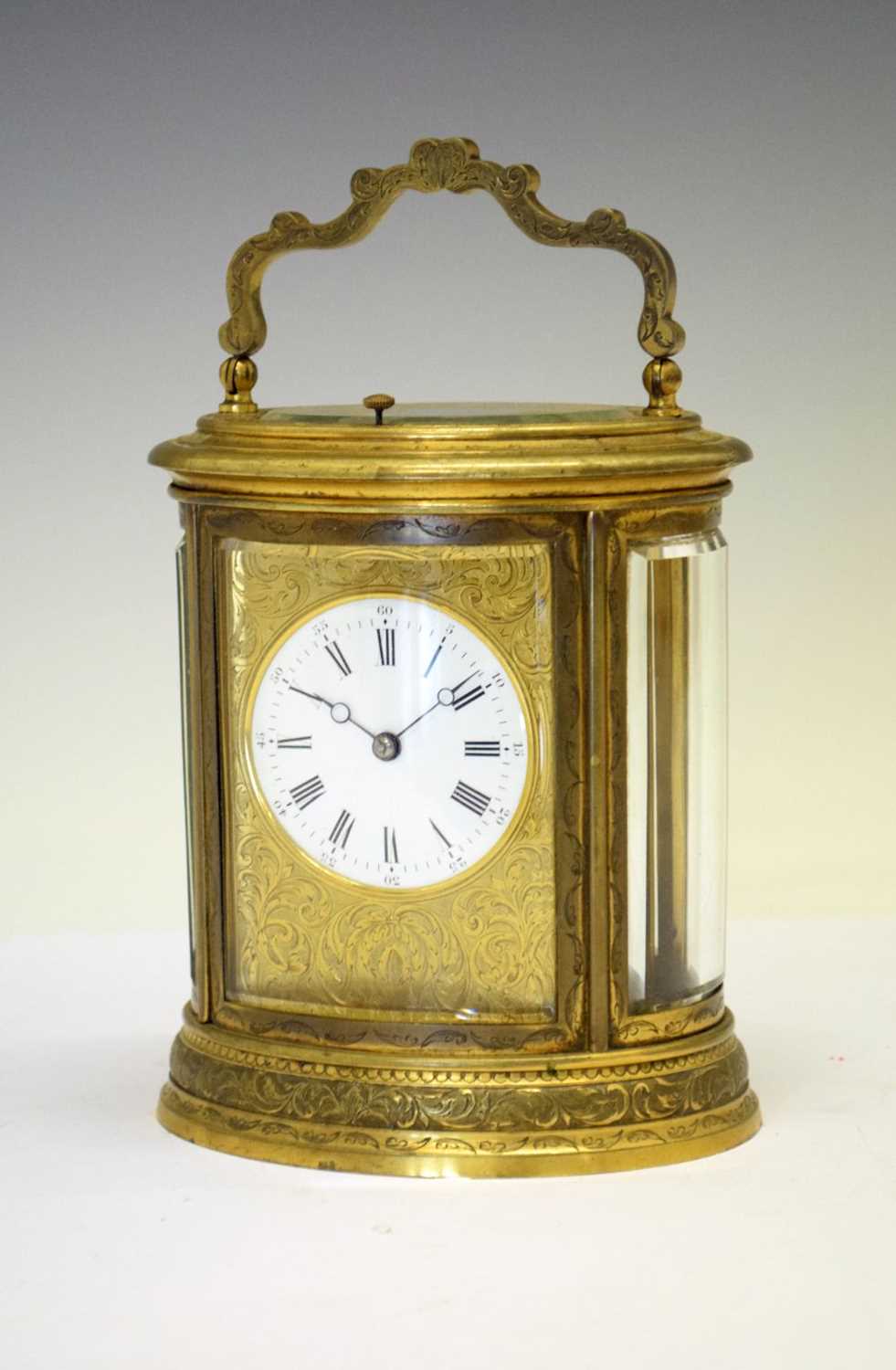 Oval engraved brass-cased repeater carriage clock