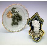 Continental majolica wall bracket together with a tin glazed olive dish