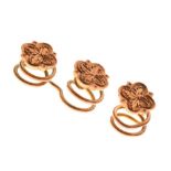 Three small rose gold flower design studs