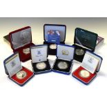 Seven GB silver proof crowns and five-pound coins in presentation cases