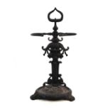 Cast iron stick stand, having mask and floral decoration