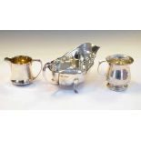 George V silver sauce boat, an Edward VII silver cream jug, and a George V silver christening mug