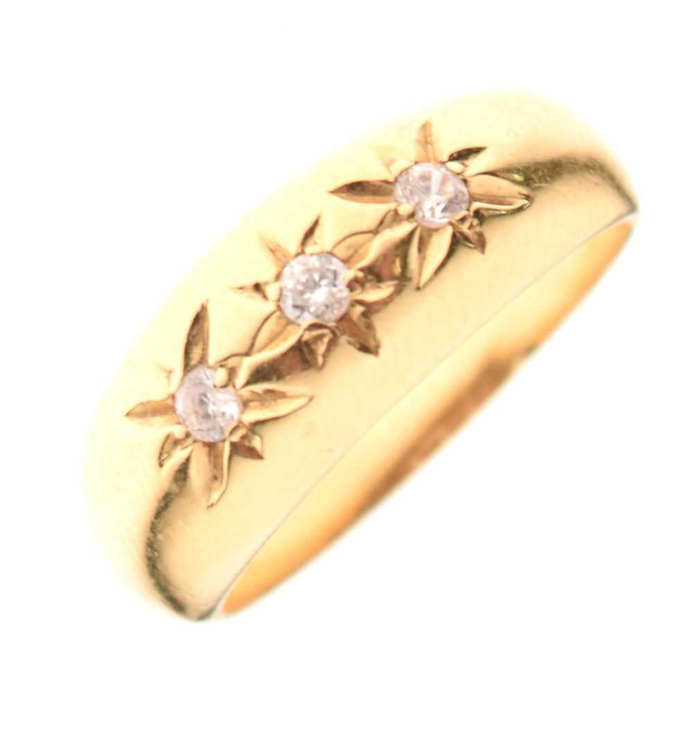 '18ct' yellow metal ring set three white stones