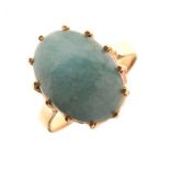 Yellow metal ring set green hardstone cabochon