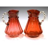 Pair of cranberry glass ewers