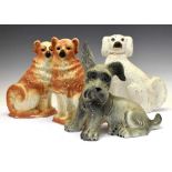 Three Staffordshire dogs and one other