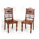 Two late Victorian or Edwardian walnut hall chairs