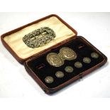 Cased matched set of six Edwardian silver buttons and two piece buckle