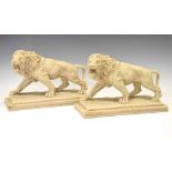 Pair of resin lions in walking position