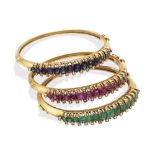 Three 18kt yellow gold, rubies, sapphires and emerald bangle bracelets 1940/50s weight 82 gr.