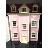 Pink dolls house with a quantity of dolls house furniture, accessories and empty dolls furniture