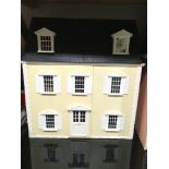 Cream dolls house with a quantity of dolls house furniture, accessories and empty dolls furniture