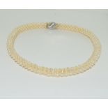 A Cultured seed pearl 15ct gold clasp choker necklace.