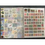 Multi coloured album of NZ stamps.