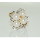 A 9ct gold ladies diamond and pearly cluster ring, Size N. 4.9g