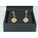 A pair of 14ct gold and diamond drop earrings.