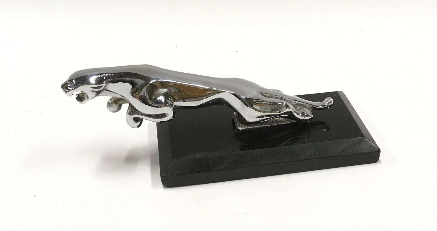 Jaguar car mascot mounted on onyx base.