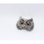 Silver owl brooch with glass eyes.