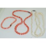 A long vintage strand of natural angel skin coral beads - 28 grams together with a necklace and